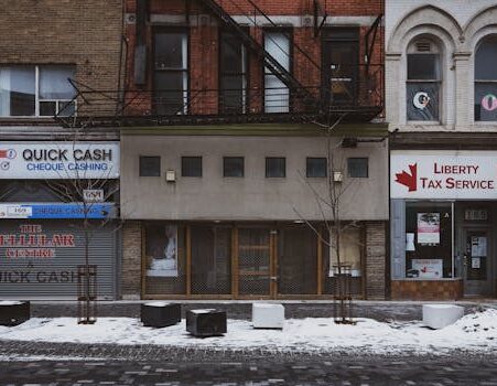 Facade of shops on a snowy street in London, Ontario, Canada.